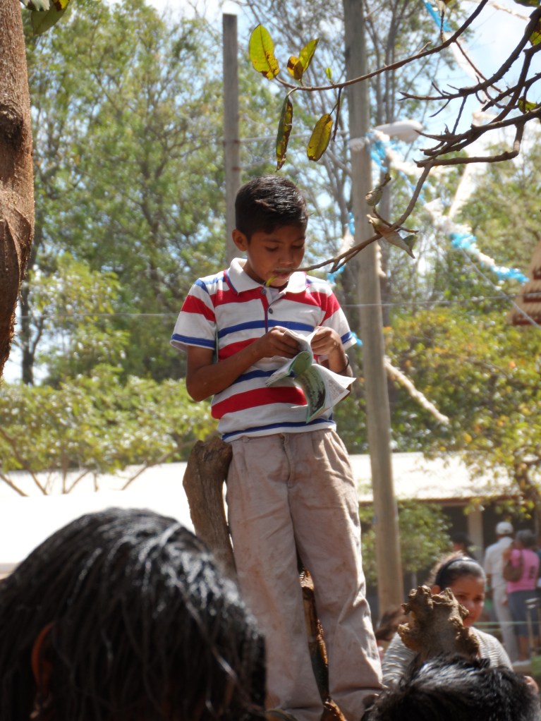 A young boy reading through his new Gospel of John.