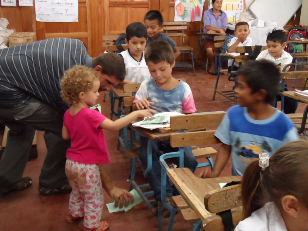 Paige handing out Gospels of John in a classroom in Nicaragua.
