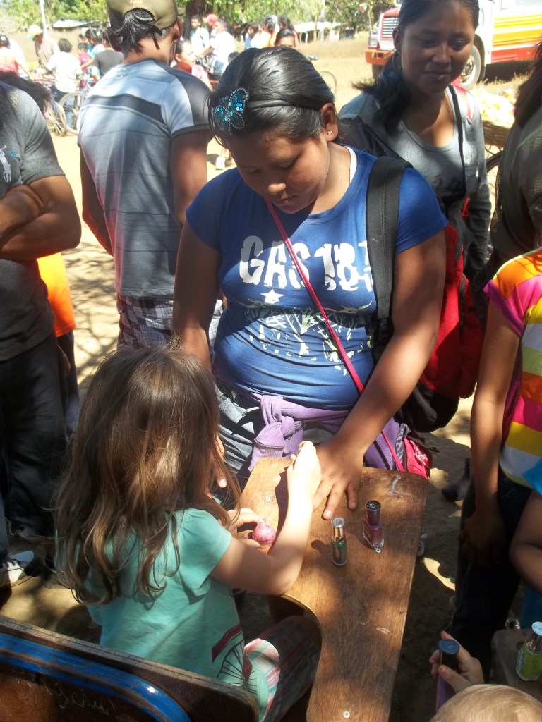 Emma painting nails during Med-Fest. 